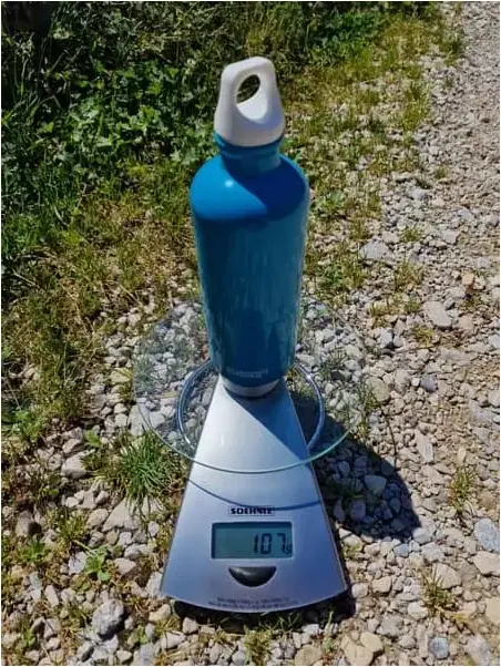 Metal hiking bottle on mountain trail